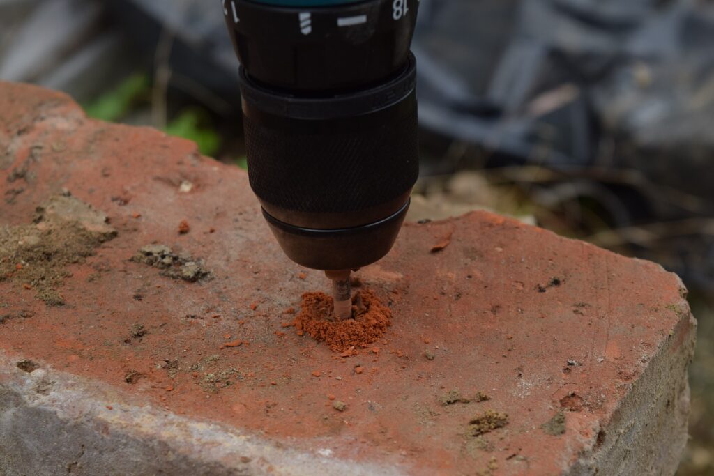 Drilling into a brick